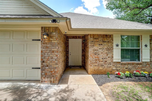 1414 Cheyenne Trl, Granbury, TX 76048 - property entrance featuring roof with shingles, brick siding, and a garage