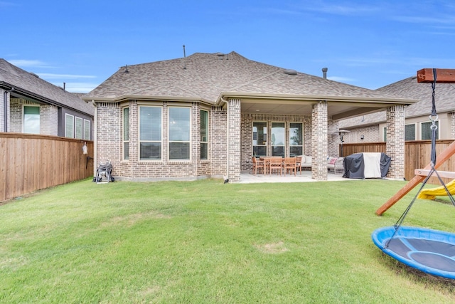 1415 Misty Pasture Way, Mansfield, TX 76063 - back of house featuring brick siding, a patio, a fenced backyard, and roof with shingles