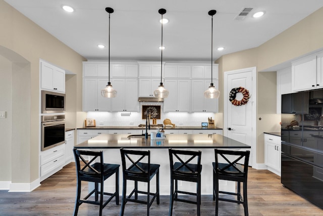 1415 Misty Pasture Way, Mansfield, TX 76063 - kitchen with stainless steel oven, built in microwave, dark countertops, decorative backsplash, and recessed lighting