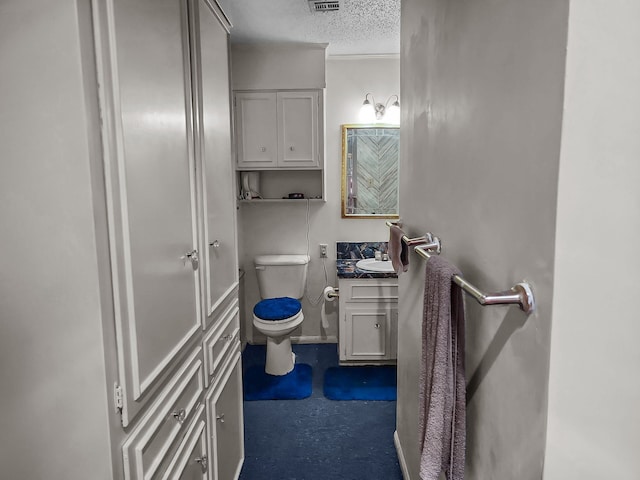 2641 Woodmont Cir, Waco, TX 76710 - half bathroom featuring a textured ceiling and vanity