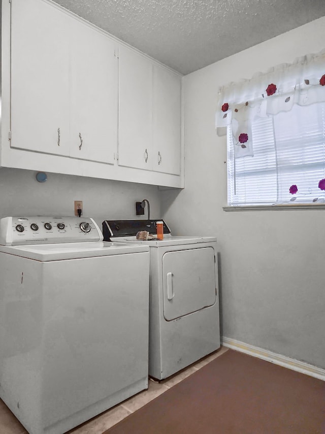 2641 Woodmont Cir, Waco, TX 76710 - laundry room with washing machine and dryer, cabinet space, and a textured ceiling