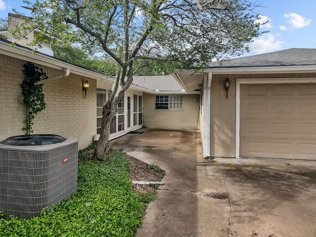 2641 Woodmont Cir, Waco, TX 76710 - exterior space featuring brick siding, a garage, and roof with shingles