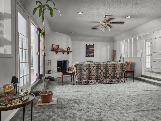 2641 Woodmont Cir, Waco, TX 76710 - carpeted living room with plenty of natural light, a textured ceiling, ceiling fan, a fireplace, and recessed lighting