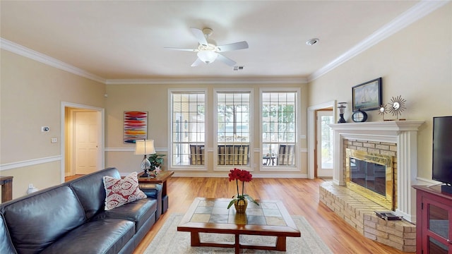 22770 Diamond Bay Dr, Frankston, TX 75763 - living room with light wood-style floors, crown molding, a ceiling fan, and a glass covered fireplace