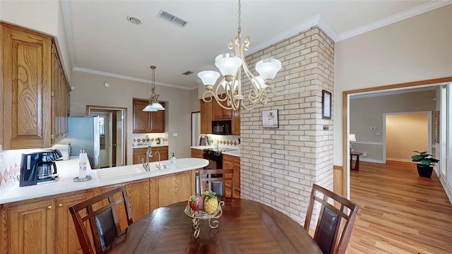 22770 Diamond Bay Dr, Frankston, TX 75763 - dining space with a chandelier, ornamental molding, light wood-style flooring, and brick wall