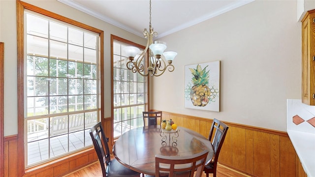 22770 Diamond Bay Dr, Frankston, TX 75763 - dining area featuring a chandelier, a wainscoted wall, crown molding, light wood finished floors, and wood walls