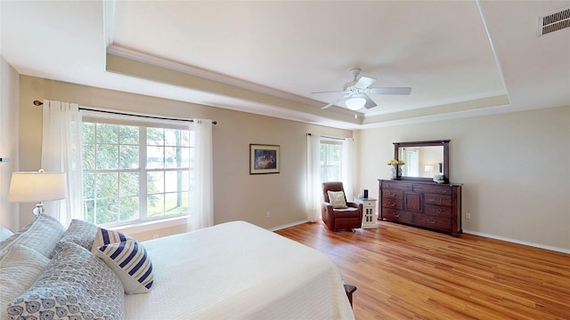22770 Diamond Bay Dr, Frankston, TX 75763 - bedroom with a raised ceiling, light wood-style flooring, crown molding, and ceiling fan