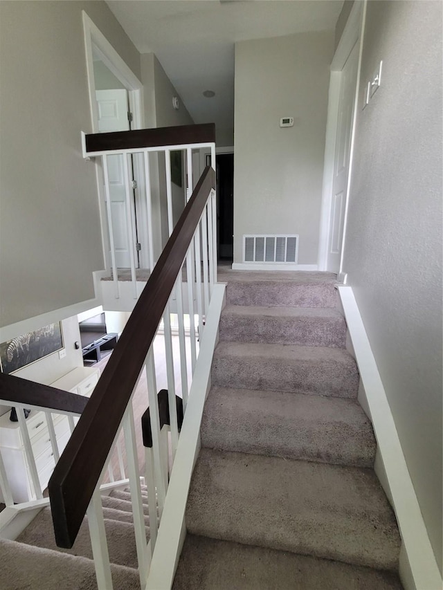 3309 Graybar Dr, Garland, TX 75040 - stairway featuring carpet