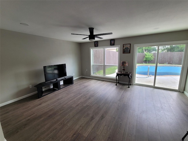 3309 Graybar Dr, Garland, TX 75040 - unfurnished living room with ceiling fan and dark wood-style flooring