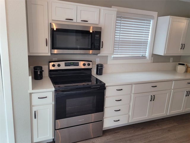 3309 Graybar Dr, Garland, TX 75040 - kitchen featuring stainless steel appliances, white cabinetry, and dark wood finished floors