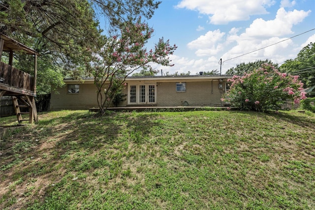 431 Brookwood Dr, Woodway, TX 76712 - rear view of house with brick siding, french doors, and a lawn