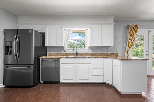 431 Brookwood Dr, Woodway, TX 76712 - kitchen featuring appliances with stainless steel finishes, a peninsula, light stone countertops, and healthy amount of natural light
