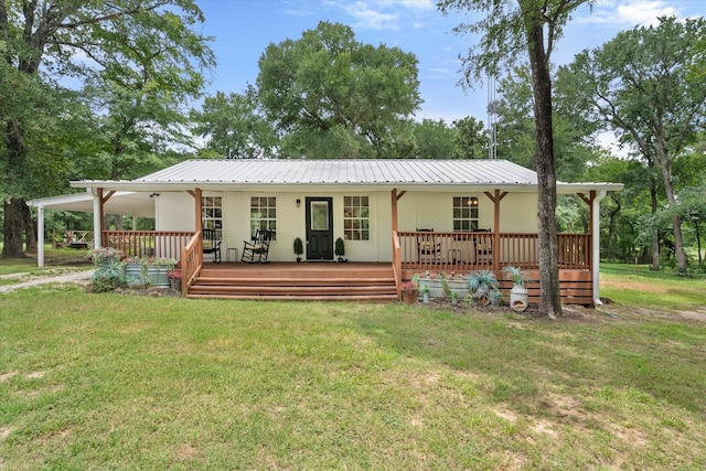3121 SE County Road 2135, Corsicana, TX 75109 - rear view of house with a yard, a metal roof, and an attached carport