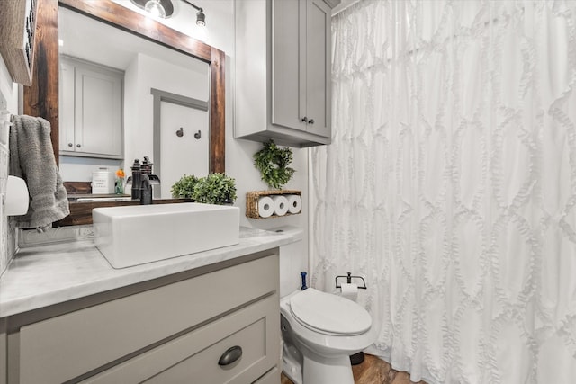 3121 SE County Road 2135, Corsicana, TX 75109 - bathroom featuring vanity, wood finished floors, and a shower with curtain