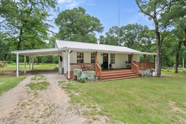 3121 SE County Road 2135, Corsicana, TX 75109 - view of front of home featuring driveway, a front lawn, a carport, a metal roof, and covered porch