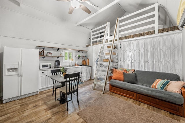 3121 SE County Road 2135, Corsicana, TX 75109 - living room with a ceiling fan, light wood-style floors, and lofted ceiling