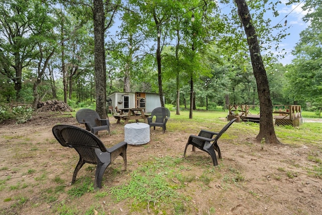 3121 SE County Road 2135, Corsicana, TX 75109 - view of yard with an outbuilding, view of scattered trees, and a wooden deck