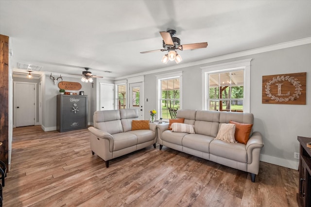 3121 SE County Road 2135, Corsicana, TX 75109 - living room featuring a ceiling fan, attic access, light wood-type flooring, and ornamental molding