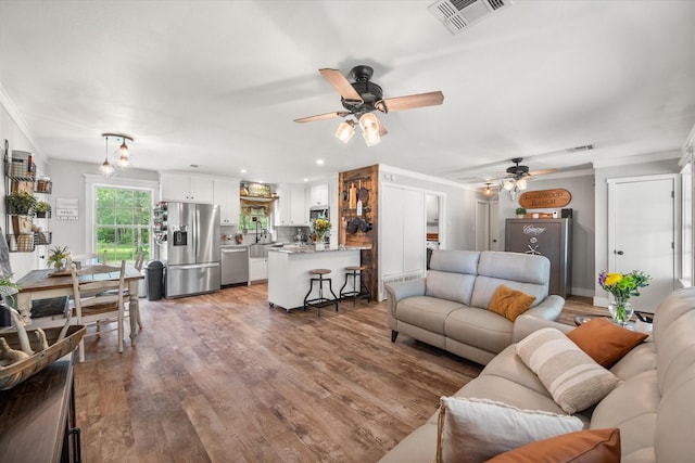 3121 SE County Road 2135, Corsicana, TX 75109 - living room with ceiling fan, wood finished floors, crown molding, and recessed lighting