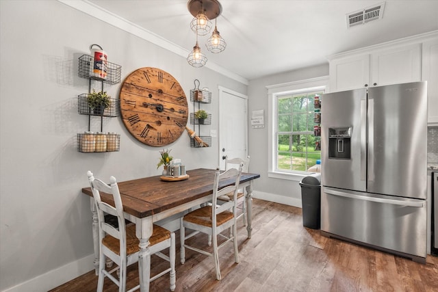 3121 SE County Road 2135, Corsicana, TX 75109 - dining space with light wood-type flooring and ornamental molding