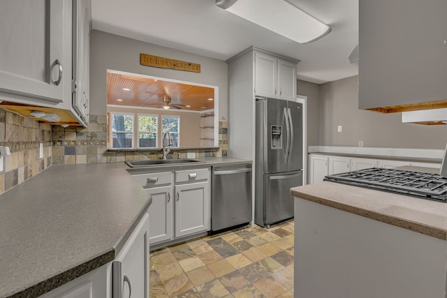 11502 Rupley Ln, Dallas, TX 75218 - kitchen with stainless steel appliances, decorative backsplash, a ceiling fan, light stone finish floors, and recessed lighting
