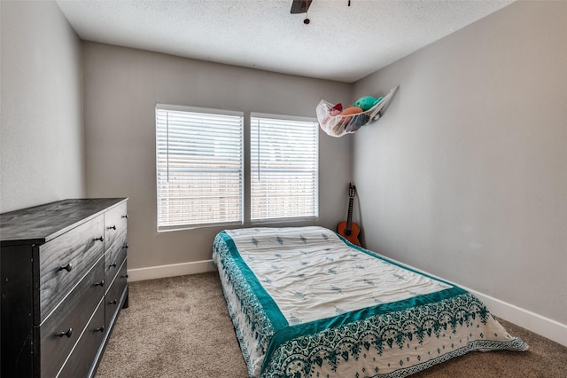 201 E Davis Ave, Alvarado, TX 76009 - bedroom featuring light colored carpet, a textured ceiling, and ceiling fan