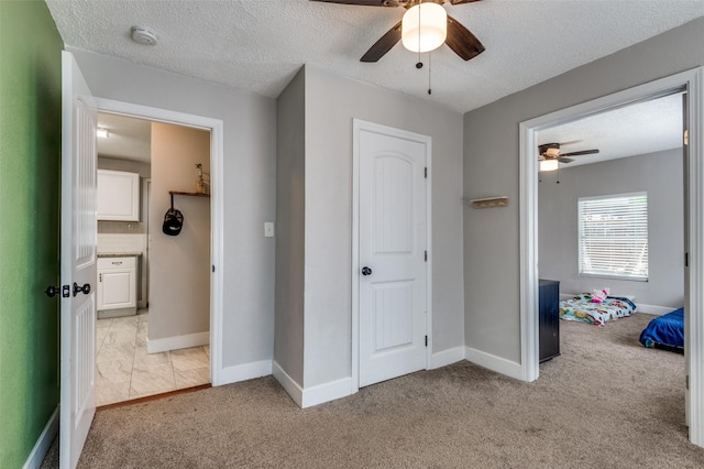 201 E Davis Ave, Alvarado, TX 76009 - unfurnished bedroom with light colored carpet, a textured ceiling, and ceiling fan