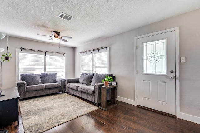 201 E Davis Ave, Alvarado, TX 76009 - living area featuring dark wood-style flooring, ceiling fan, and a textured ceiling