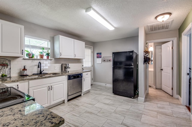 201 E Davis Ave, Alvarado, TX 76009 - kitchen featuring black appliances, plenty of natural light, backsplash, white cabinetry, and a textured ceiling