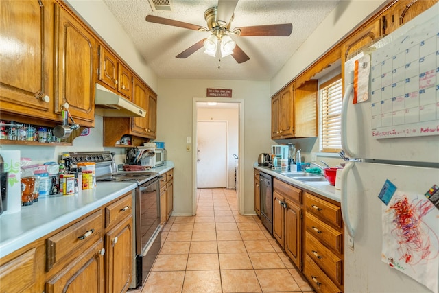 1638 Brown Trl, Hurst, TX 76054 - kitchen featuring stainless steel appliances, under cabinet range hood, light countertops, brown cabinetry, and a textured ceiling