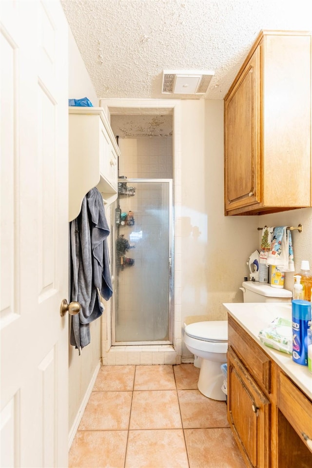 1638 Brown Trl, Hurst, TX 76054 - full bath featuring tile patterned floors, a shower stall, vanity, and a textured ceiling