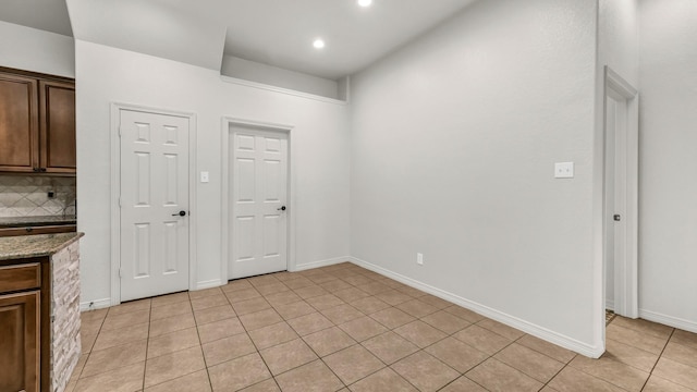 914 Randall Rd, Weatherford, TX 76087 - kitchen with light tile patterned floors, backsplash, stone countertops, recessed lighting, and dark brown cabinets