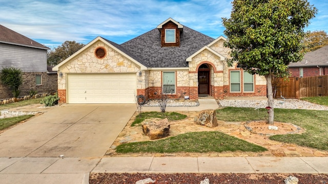 914 Randall Rd, Weatherford, TX 76087 - view of front facade with stone siding, a garage, concrete driveway, and brick siding