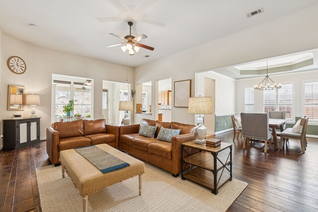 6044 Larkspur Ln, Frisco, TX 75036 - living area featuring healthy amount of natural light, dark wood-type flooring, a ceiling fan, and a chandelier