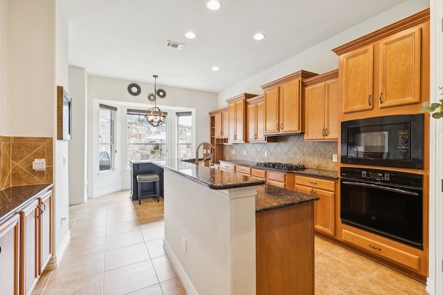 6044 Larkspur Ln, Frisco, TX 75036 - kitchen with black appliances, light tile patterned floors, dark stone countertops, tasteful backsplash, and an island with sink