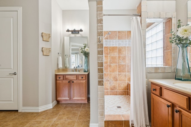 6044 Larkspur Ln, Frisco, TX 75036 - bathroom with a tile shower, two vanities, and tile patterned floors
