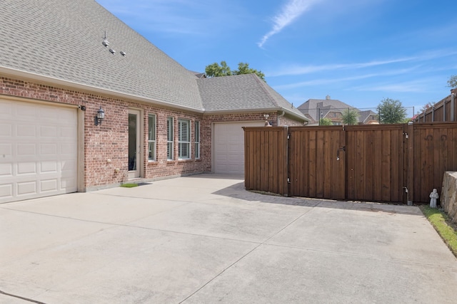 6044 Larkspur Ln, Frisco, TX 75036 - view of patio / terrace with concrete driveway, a gate, and an attached garage