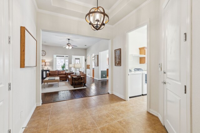 6044 Larkspur Ln, Frisco, TX 75036 - hallway featuring washer and dryer, tile patterned floors, a chandelier, and ornamental molding