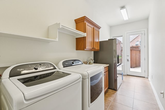 6044 Larkspur Ln, Frisco, TX 75036 - laundry area featuring cabinet space, separate washer and dryer, and light tile patterned floors