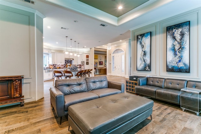 1600 Crockett Cir, Irving, TX 75038 - living area featuring crown molding, light wood-type flooring, recessed lighting, and a tray ceiling
