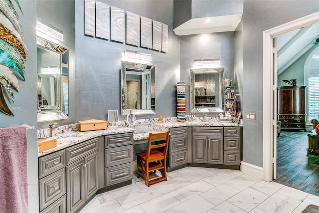 1600 Crockett Cir, Irving, TX 75038 - full bathroom with vanity, marble look tile flooring, and a high ceiling
