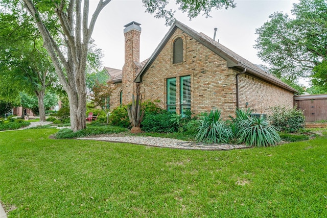 1600 Crockett Cir, Irving, TX 75038 - view of side of home featuring brick siding, a lawn, and a chimney