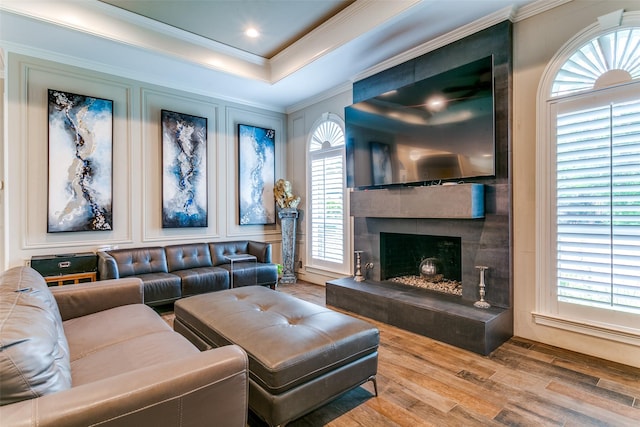 1600 Crockett Cir, Irving, TX 75038 - living area with wood finished floors, ornamental molding, a fireplace, and a raised ceiling