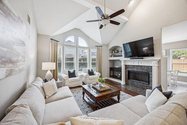 3805 Blaylock Pl, Plano, TX 75025 - living room featuring a ceiling fan, a fireplace, wood finished floors, built in features, and high vaulted ceiling