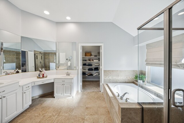 3805 Blaylock Pl, Plano, TX 75025 - bathroom featuring double vanity, a stall shower, a bath, vaulted ceiling, and a spacious closet