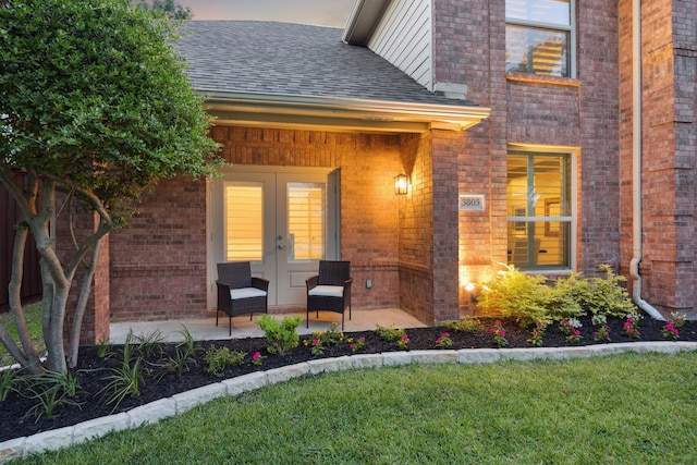3805 Blaylock Pl, Plano, TX 75025 - entrance to property featuring french doors, a shingled roof, brick siding, and a yard