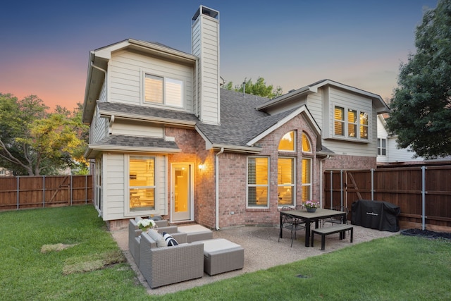 3805 Blaylock Pl, Plano, TX 75025 - back of house at dusk with brick siding, a shingled roof, a chimney, a fenced backyard, and a patio area