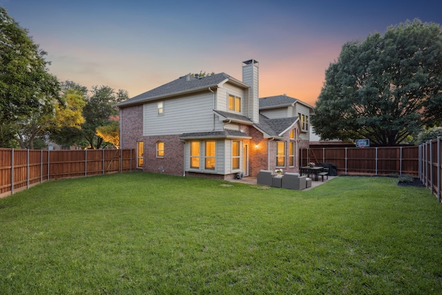 3805 Blaylock Pl, Plano, TX 75025 - back of house at dusk featuring a chimney, outdoor lounge area, brick siding, a fenced backyard, and a patio area
