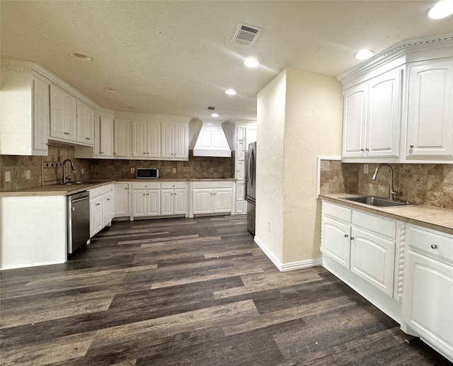 7804 Daniel Dr, North Richland Hills, TX 76182 - kitchen featuring stainless steel appliances, custom exhaust hood, decorative backsplash, dark wood-type flooring, and recessed lighting