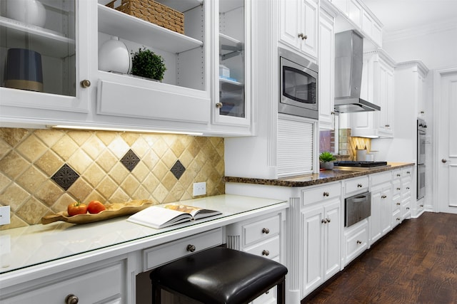 3928 Dove Creek Ln, Plano, TX 75093 - kitchen with stainless steel appliances, wall chimney exhaust hood, white cabinetry, a warming drawer, and ornamental molding